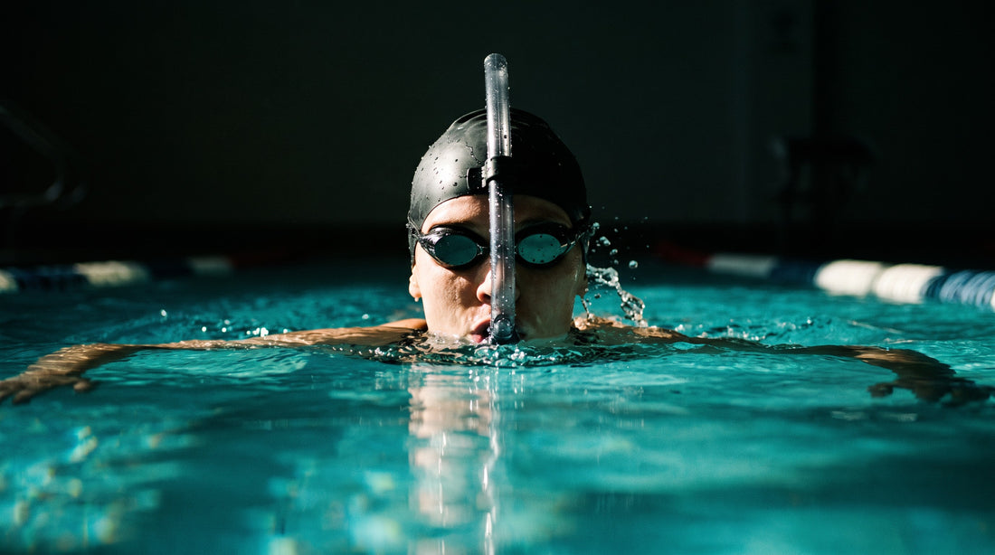 Swimmer training freestyle with a center-mount swim snorkel keeping the head level