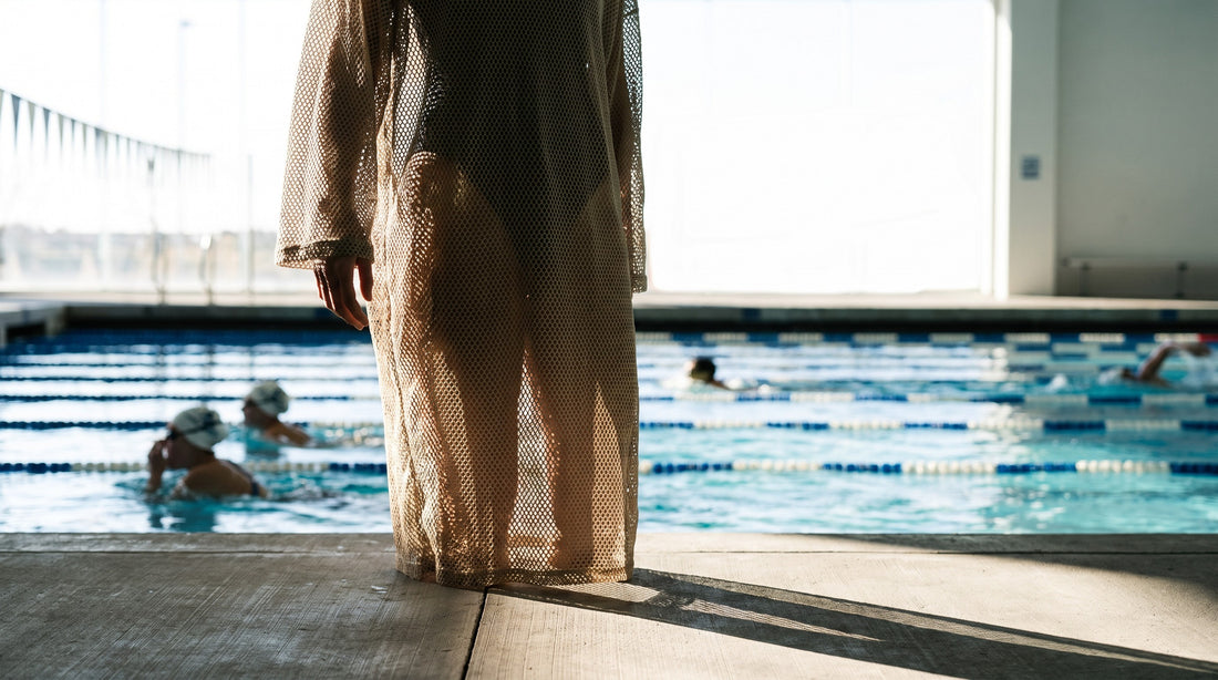 Swimmer on the pool deck wearing a mesh drag suit over a training swimsuit