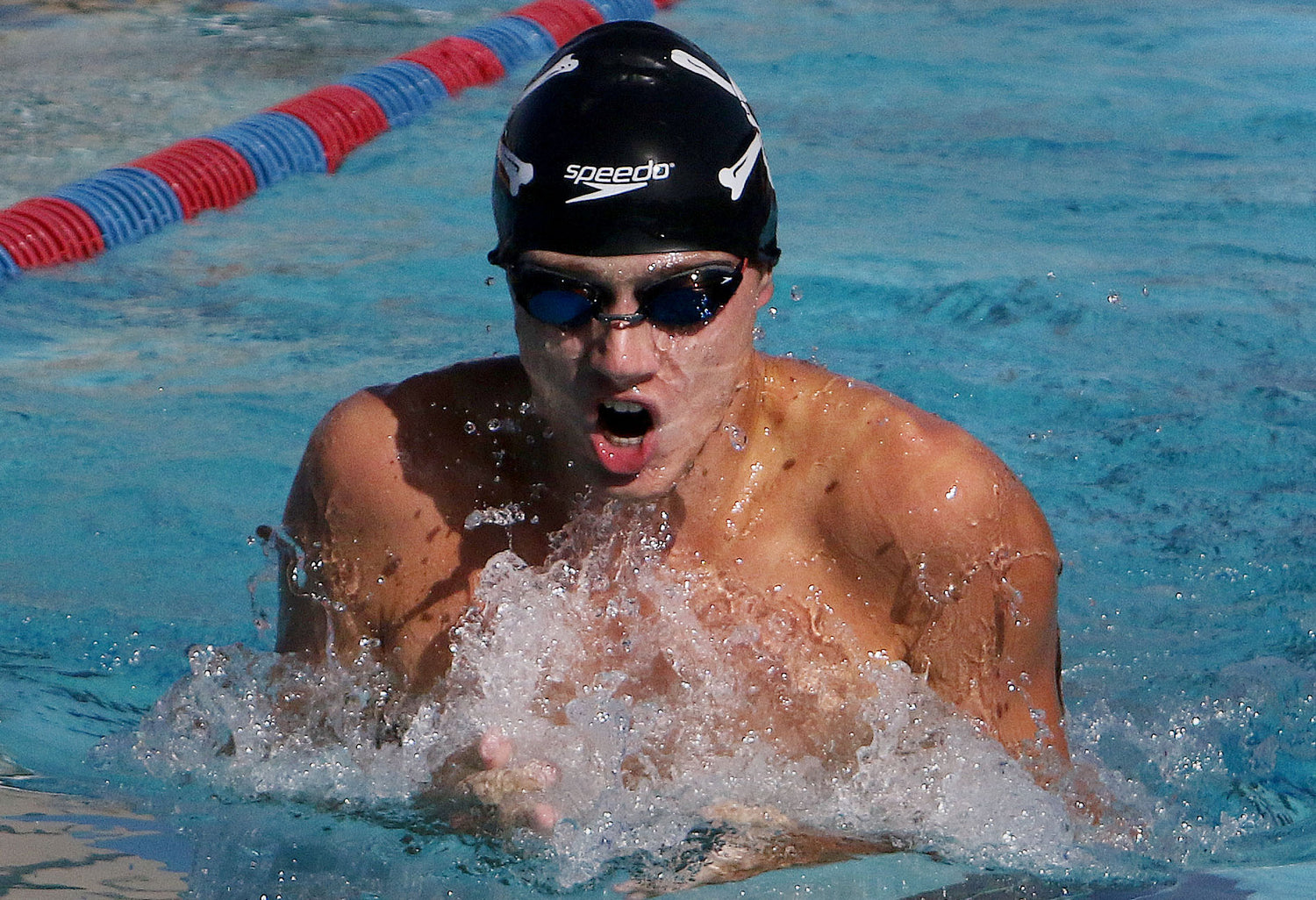 Swimmer wearing a Speedo cap and goggles in a pool