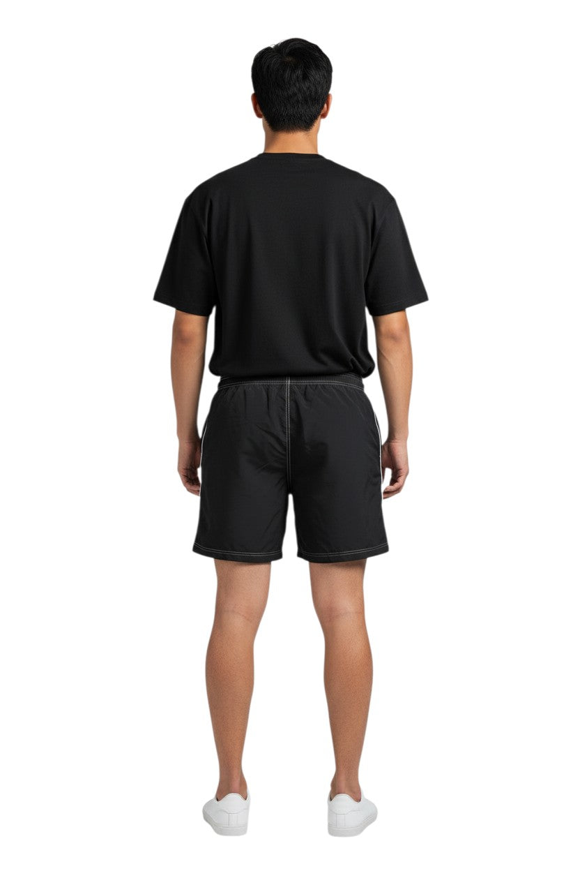 Black polyester spandex boardshorts with drawstring, contrast stitching, and side pocket.