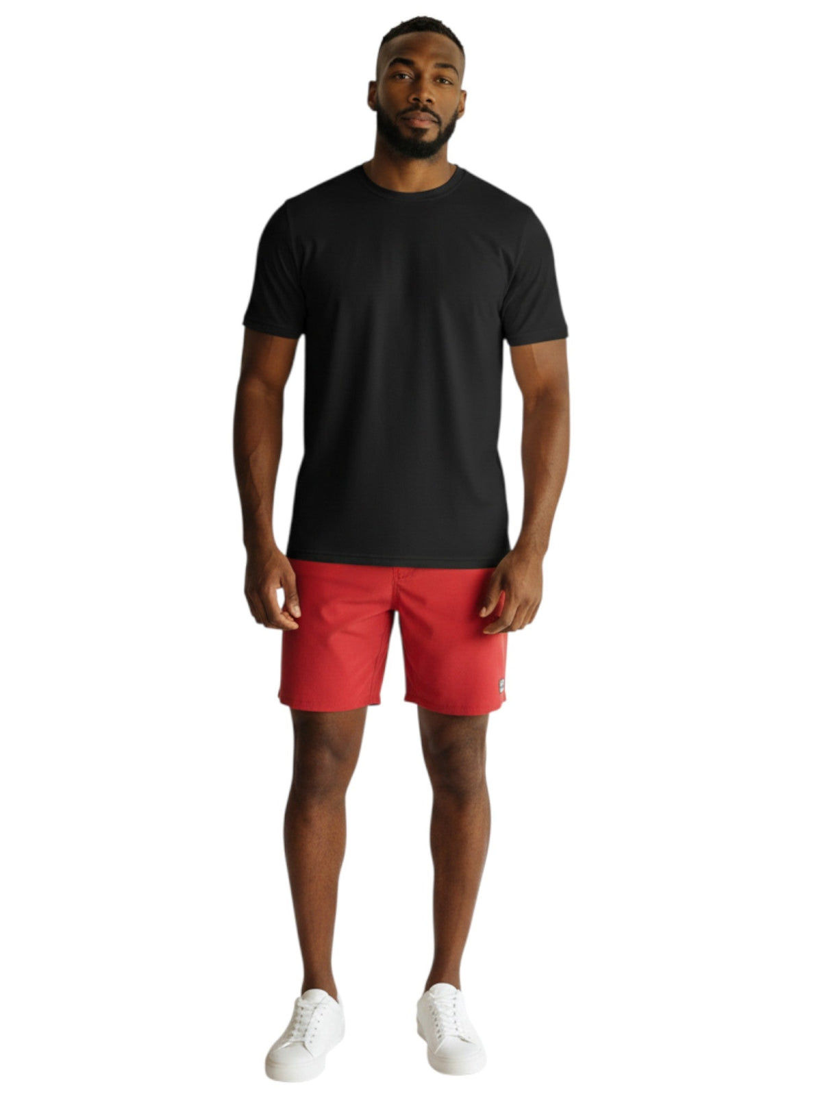 Male model wearing Kiefer black short sleeve crew neck rashguard with red shorts and white sneakers.