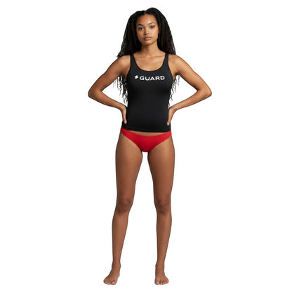 Model wearing Kiefer black racer back tankini top with white GUARD text and red bikini bottoms