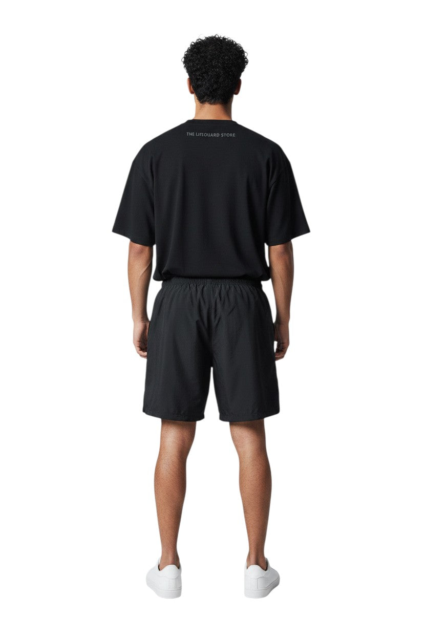 RISE Guard Male Flex Board Short in black, shown on model