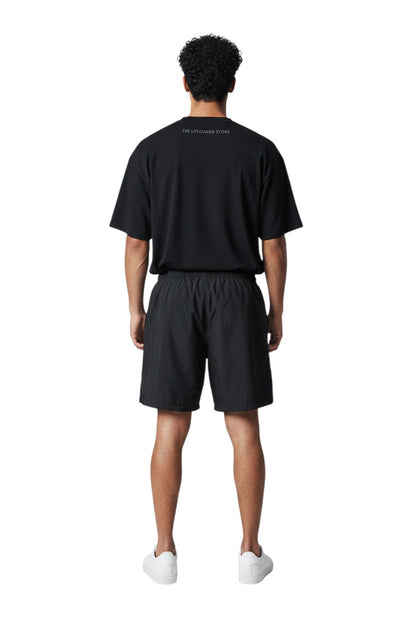 RISE Guard Male Flex Board Short in black, shown on model