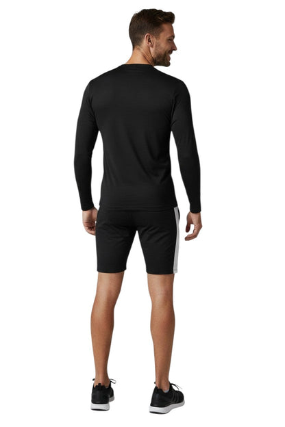 RISE Solid Long Sleeve Crew Neck Rashguard in black, shown on model