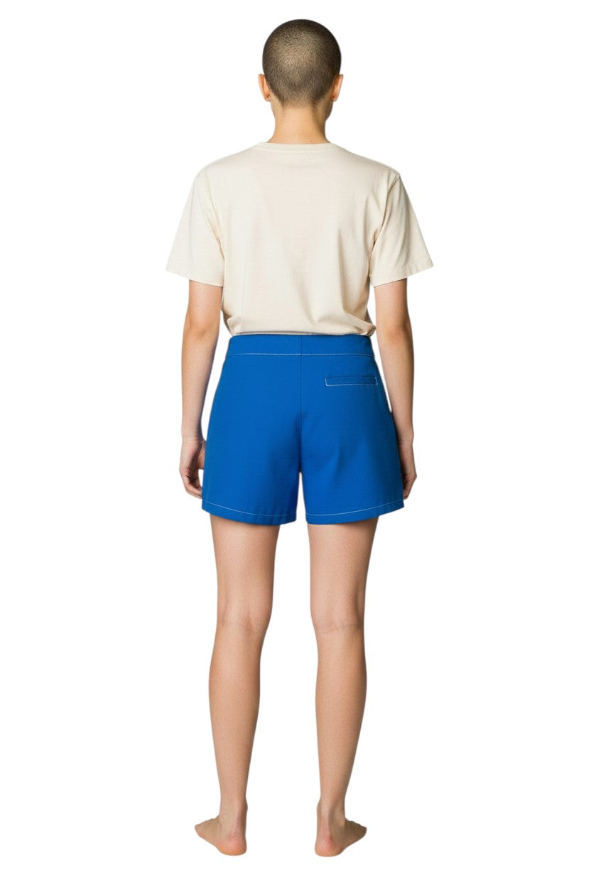 Blue polyester-spandex flex shorts with white contrast stitching and drawstring waist.