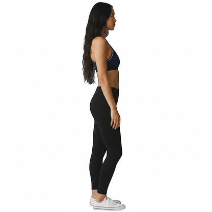 Kiefer reversible racer back top in navy blue worn by a model with black leggings and white sneakers.