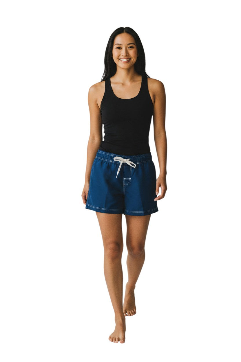 Navy blue polyester flex shorts with white drawstring and contrast stitching. Features side pocket and 5" inseam.