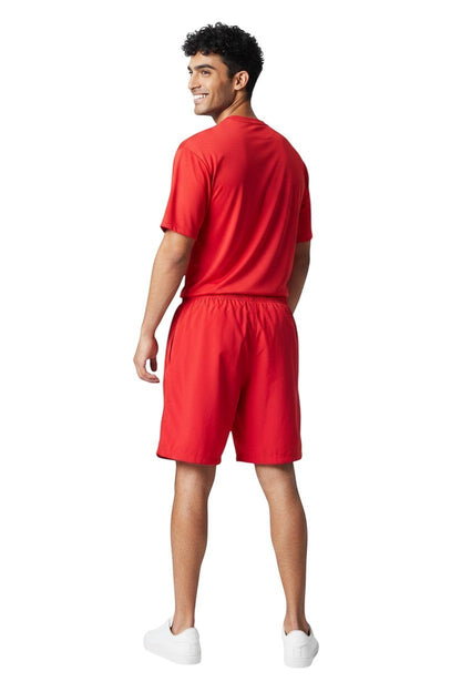 RISE Solid Male Flex Board Short in red, shown on model
