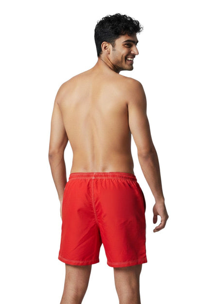 Red polyester-spandex boardshorts with contrast stitching, elastic waistband, and back pocket.