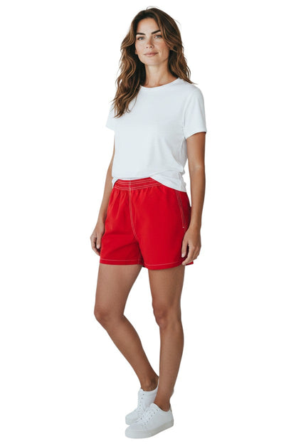 Kiefer red nylon board shorts with elastic waistband, drawstring, and side pocket. 3" inseam.