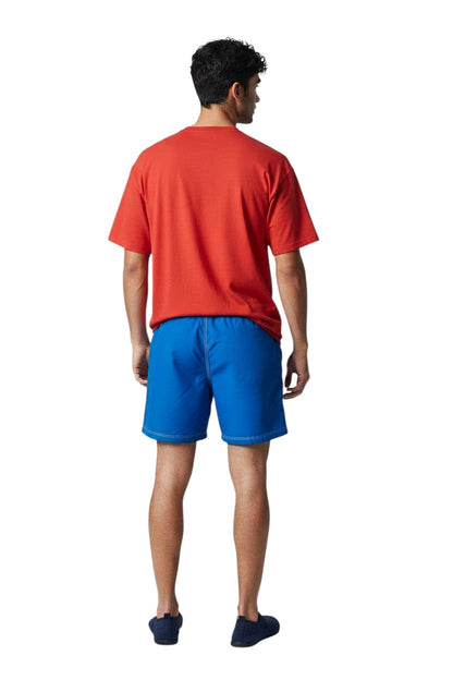 Solid Male Flex Short in royal blue, featuring contrast stitching, elastic waistband, and a back pocket.
