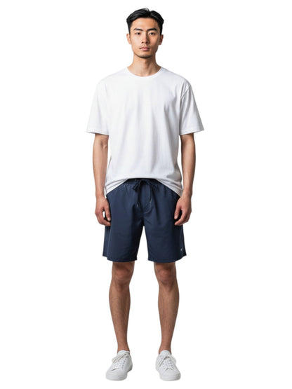 Male model wearing Kiefer white short sleeve crew neck rashguard and navy blue swim shorts
