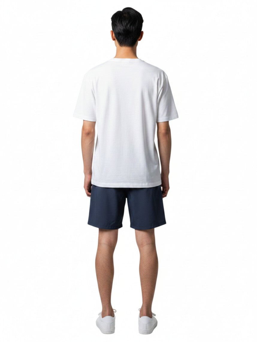 Back view of a man wearing Kiefer white short sleeve crew neck rashguard with navy blue shorts